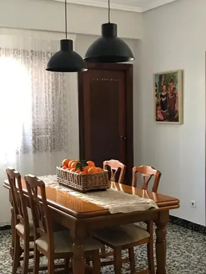 a dining room table with a basket of fruit on it at Bonito piso en el centro de Benaguacil in Benaguacil