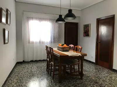 a dining room table with chairs and a basket of fruit on it at Bonito piso en el centro de Benaguacil in Benaguacil