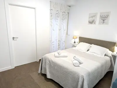 a bedroom with a bed with two towels on it at Estudios en la playa in Valencia