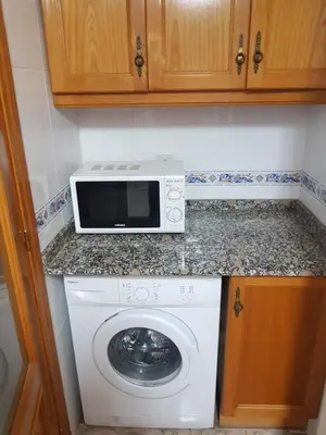a kitchen with a washing machine and a microwave at Isabel in Valencia
