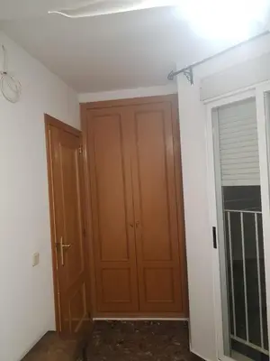 a room with a wooden door and a window at Isabel in Valencia