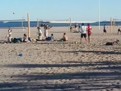 a group of people playing soccer on the beach at Isabel in Valencia