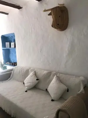 a white couch with pillows in a room at Casa Rural La Antigua in Chelva