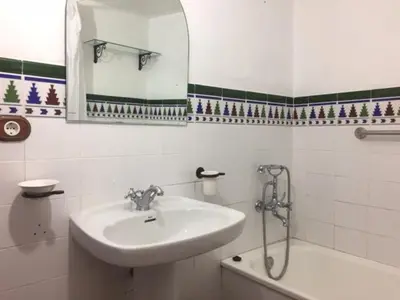 a bathroom with a sink and a mirror and a tub at Casa Rural La Antigua in Chelva