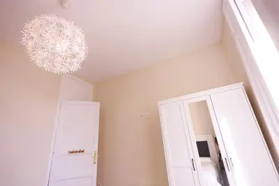 a room with a mirror and a chandelier at Apartamentos Dormavalencia in Valencia