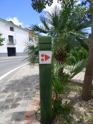 a green post with a sign on it on a street at Casa rural La Senyora in Veo