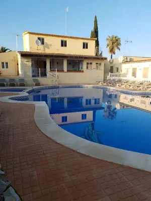 a swimming pool in front of a building at Casa Robion in Godelleta