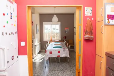 a dining room with a table with a white table cloth at Villa Rive Rouge in Riba-Roja De Turia