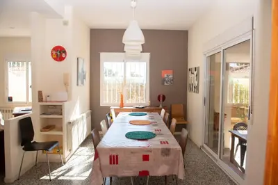 a dining room with a long table and chairs at Villa Rive Rouge in Riba-Roja De Turia