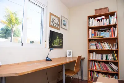 a desk in a room with a window and a book shelf at Villa Rive Rouge in Riba-Roja De Turia