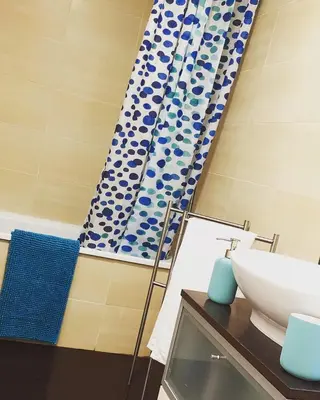 a bathroom with a sink and a shower curtain at BEACH & SUN MONCOFA in Moncófar