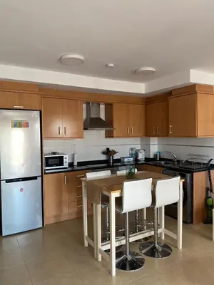 a kitchen with a table and a refrigerator at BEACH & SUN MONCOFA in Moncófar
