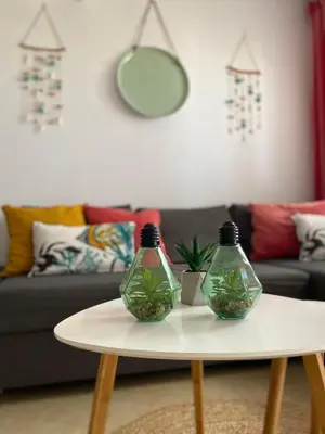 two glass bottles sitting on a table in a living room at BEACH & SUN MONCOFA in Moncófar