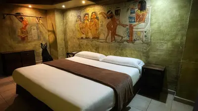 a bedroom with a bed with a painting on the wall at Casual Civilizaciones Valencia in Valencia