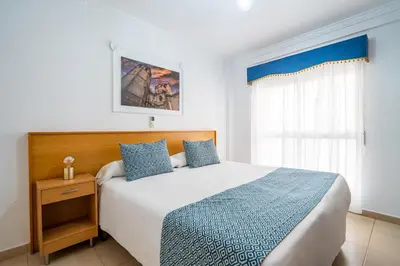 a bedroom with a large bed and a window at Hostal RR Feria by Beleret in Valencia