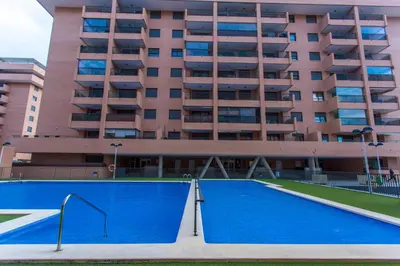 an empty swimming pool in front of a building at Apartment on the beach,pool,WiFi,garage,Valencia in Valencia
