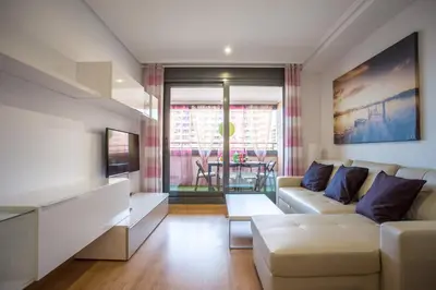 a living room with a couch and a table at Apartment on the beach,pool,WiFi,garage,Valencia in Valencia