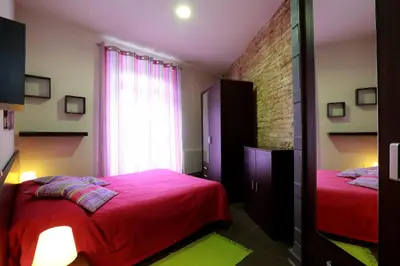 a bedroom with two beds and a window at Reino de Valencia Apartments in Valencia