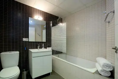 a bathroom with a toilet and a tub and a sink at Reino de Valencia Apartments in Valencia