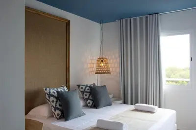 a bedroom with a bed with a blue ceiling at YOU & CO. Saler Beach Boutique in Valencia