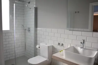 a bathroom with a sink and a toilet and a shower at YOU & CO. Saler Beach Boutique in Valencia