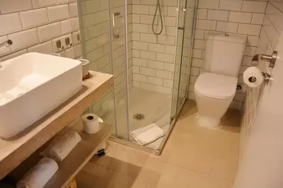 a bathroom with a shower and a sink and a toilet at YOU & CO. Saler Beach Boutique in Valencia