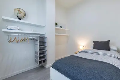 a bedroom with a bed and a clock on the wall at Travel Habitat Ruzafa Apartment in Valencia