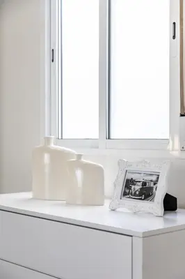 a white counter with two lights and a picture on it at Travel Habitat Ruzafa Apartment in Valencia