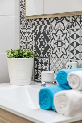 a bathroom counter with towels and a plant on it at Travel Habitat Ruzafa Apartment in Valencia