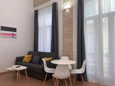 a living room with a couch and a table at Old Town Flats Casa Burguerini in Valencia