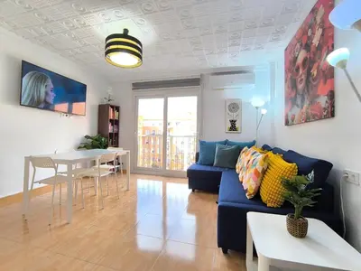 a living room with a blue couch and a table at Valencia Central Apartment two bedrooms for Rent from more than 10 days in Valencia