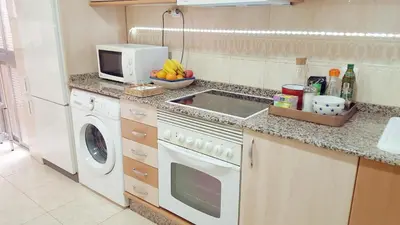 a kitchen with a sink and a washing machine at Valencia Central Apartment two bedrooms for Rent from more than 10 days in Valencia