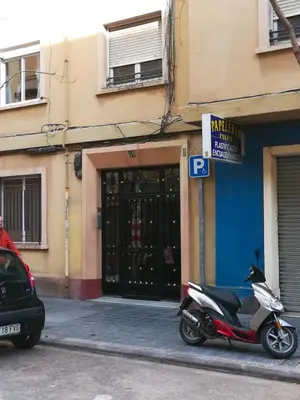 a scooter parked on a street in front of a building at MARIETA in Valencia