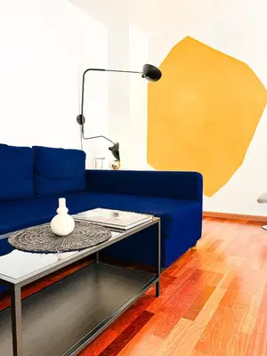 a blue couch in a living room with a table at Happy Apartments Valencia in Valencia