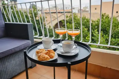 a table with two drinks and croissants on a balcony at Atarazanas Flat in Valencia