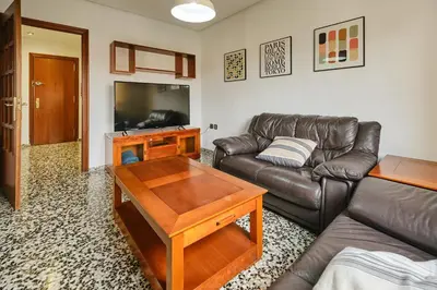 a living room with a leather couch and a table at Atarazanas Flat in Valencia