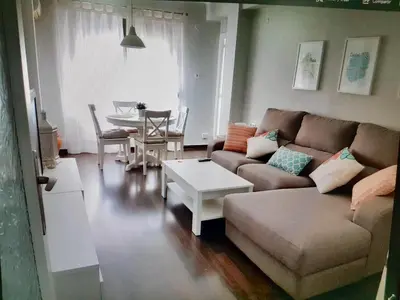 a living room with a couch and a table at Apartamento cerca de la playa y Ciudad de las Ciencias in Valencia