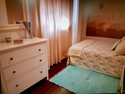 a small bedroom with a bed and a dresser at Apartamento cerca de la playa y Ciudad de las Ciencias in Valencia