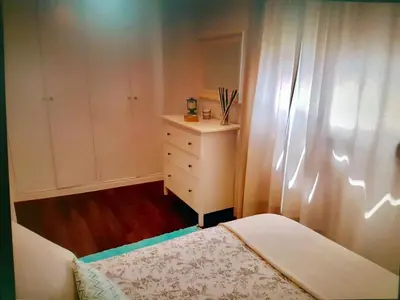 a small bedroom with a bed and a dresser at Apartamento cerca de la playa y Ciudad de las Ciencias in Valencia