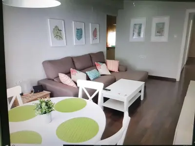a living room with a couch and a table at Apartamento cerca de la playa y Ciudad de las Ciencias in Valencia