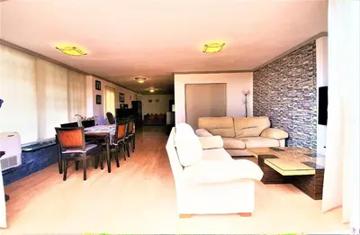 a living room with white furniture and a brick wall at APARTAMENTO CERCA DE PLAYA Y MONTAÑA IDEAL FAMILIAS O RELAX in Puzol