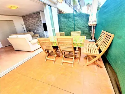 a patio with a table and chairs and a couch at APARTAMENTO CERCA DE PLAYA Y MONTAÑA IDEAL FAMILIAS O RELAX in Puzol