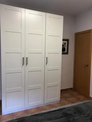 a closet with white doors in a room at Colón Market Downtown in Valencia