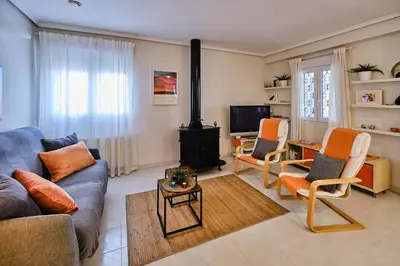 a living room with a couch and chairs and a fireplace at Penthouse Inlakesh in Valencia