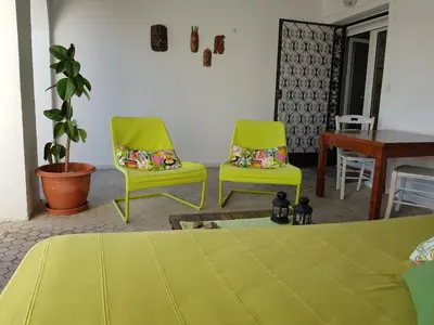 two green chairs and a table in a room at Penthouse Inlakesh in Valencia