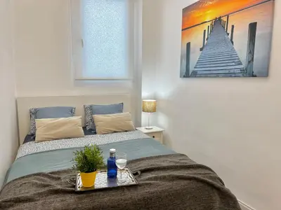 a bedroom with a bed with a tray on it at Apartment near the BIO PARC in Valencia
