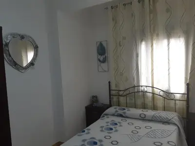 a bedroom with a bed and a window at Habitación San Cayetano in Valencia