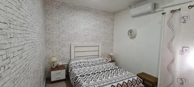 a bedroom with a bed with a blanket on it at Habitación San Cayetano in Valencia