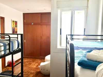 a room with two bunk beds and a closet at Rio Turia Skatehouse in Valencia