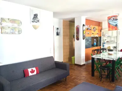 a living room with a couch and a table at Rio Turia Skatehouse in Valencia